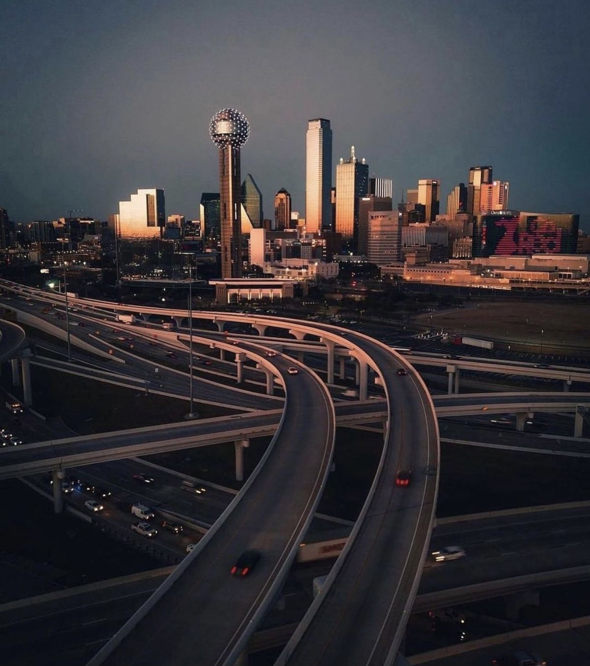 Dallas skyline at dusk with the Reunion Tower and glowing highways